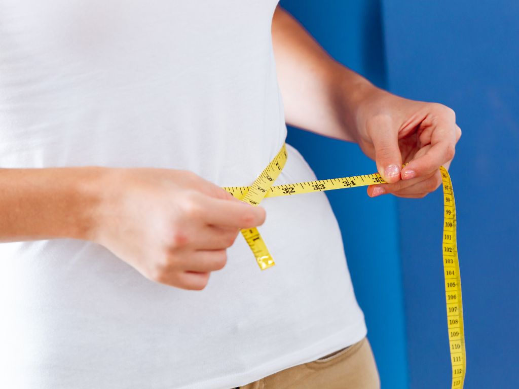 Person measuring waistline