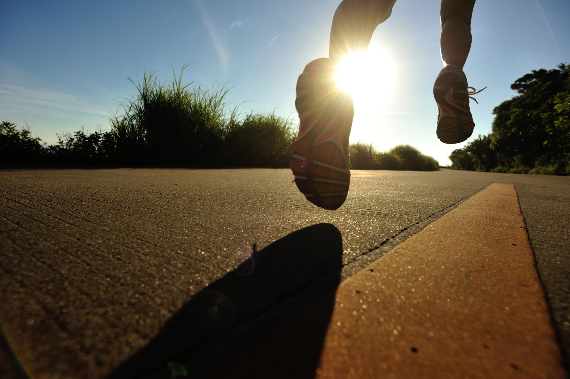 young fitness woman running on sunrise seaside trail