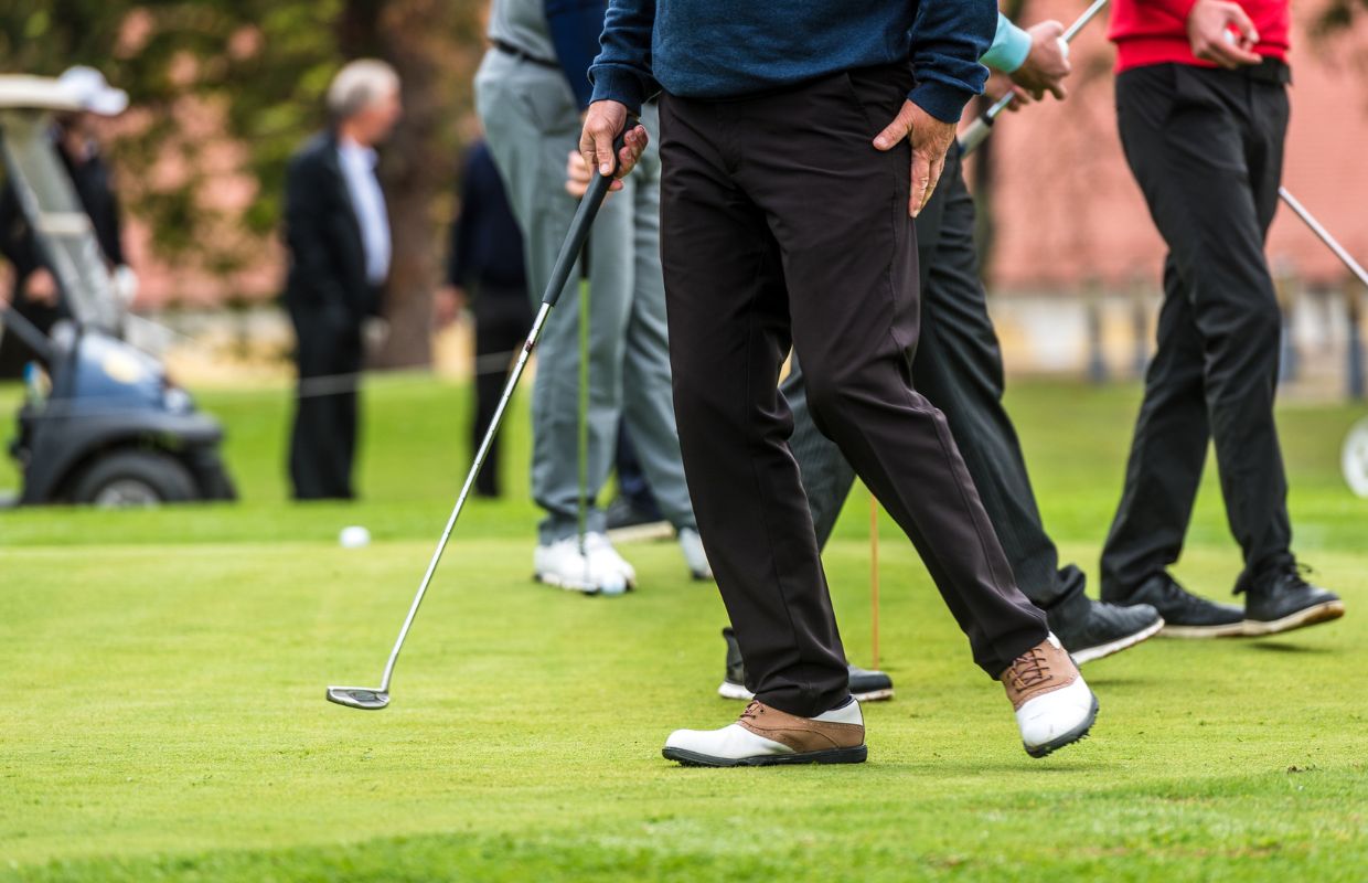 Many golfers gathered on a golf course