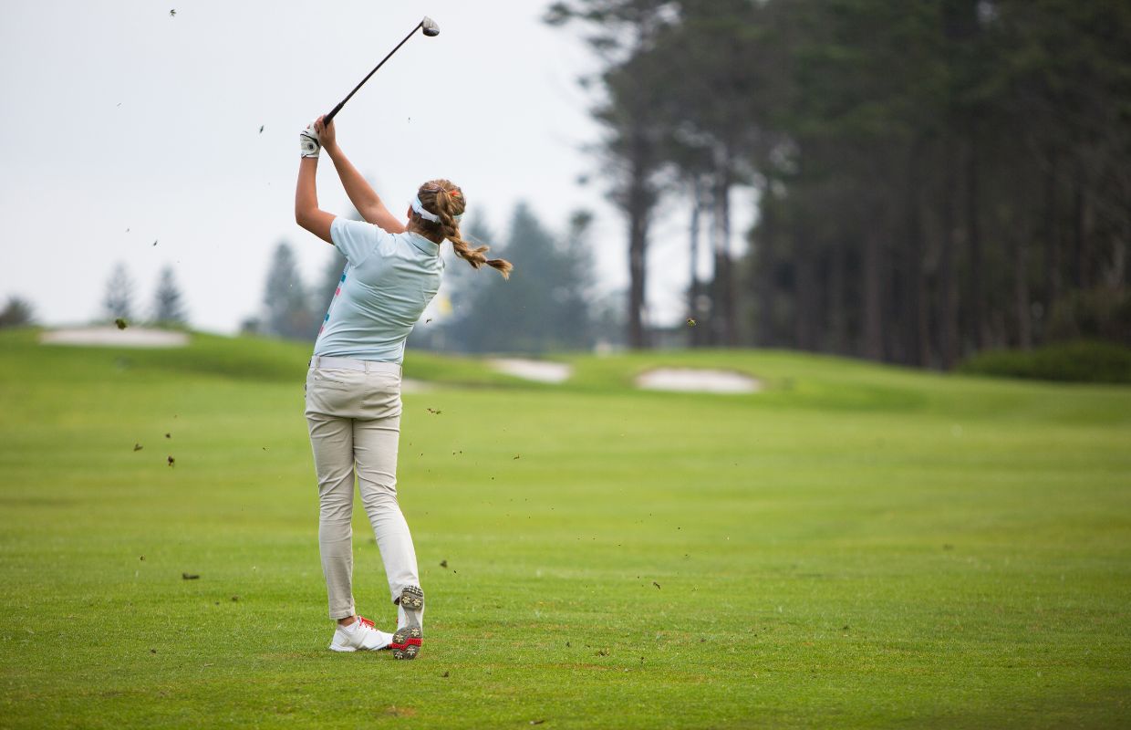 Golfer practicing her swing