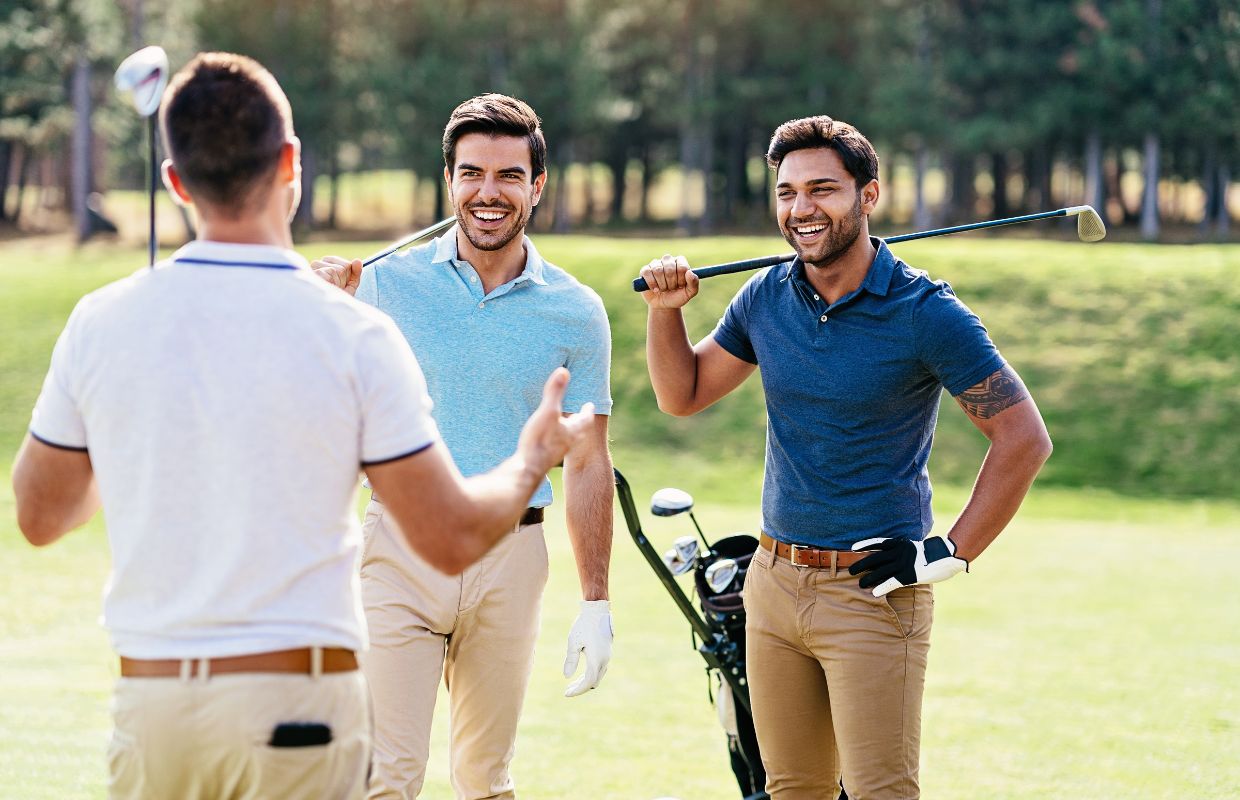 Three golfers standing on a golf course