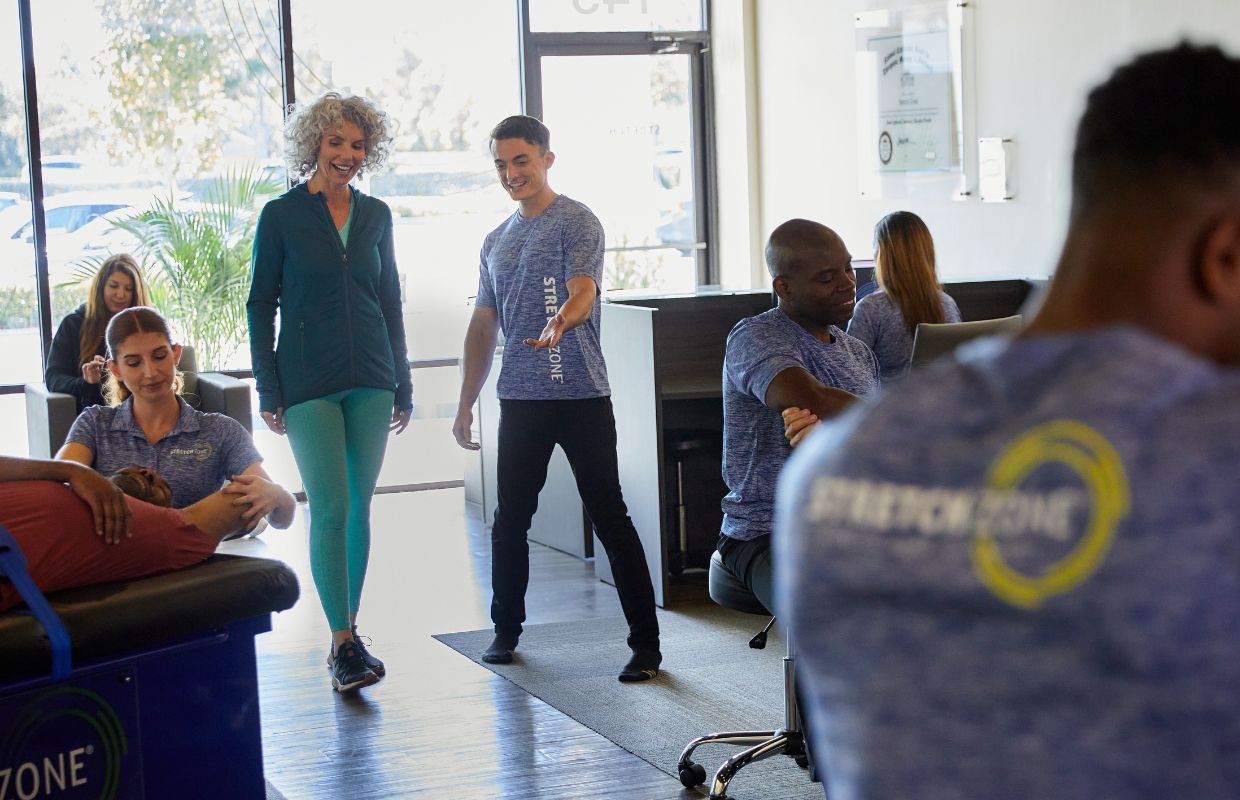 Stretch practitioner welcoming client into Stretch Zone studio