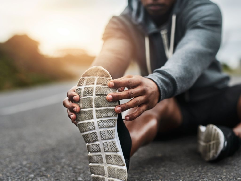 Person performing a hamstring stretch during a workout
